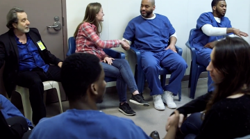 Students shake hands during the MIT Prison Education Program. A documentary film about the program has won a New England Emmy Award.