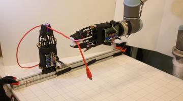 The system uses a pair of soft robotic grippers with high-resolution tactile sensors to successfully manipulate freely moving cables.Photo courtesy of MIT CSAIL.